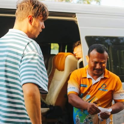 Our coordinator helping a traveller board the minivan